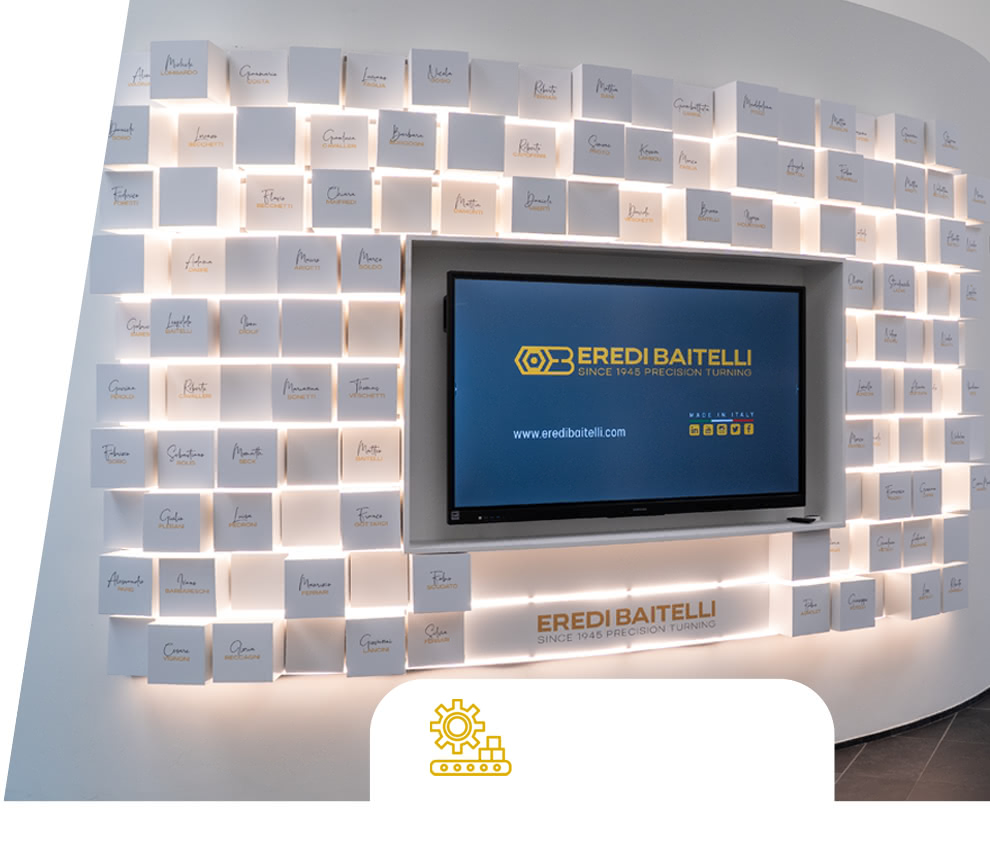 Eredi Baitelli Wall of Fame: illuminated wall with name tiles and a display screen in the entrance area.
