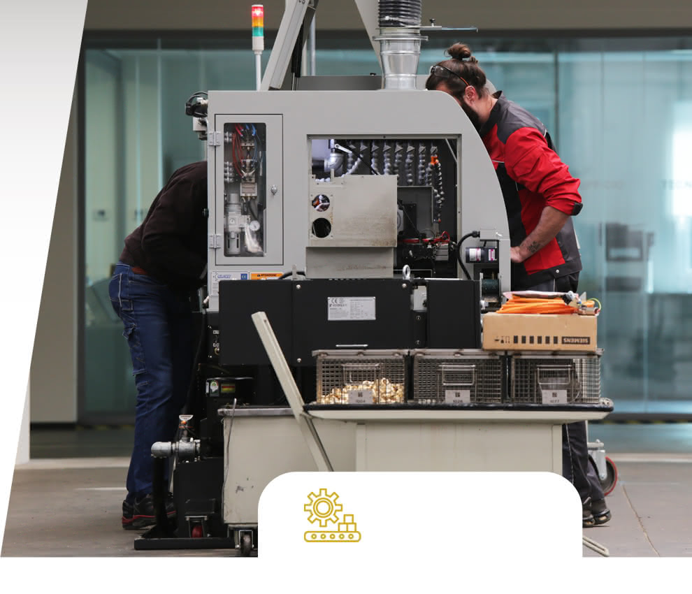 Eredi Baitelli operators at work on a CNC lathe, with baskets full of turned components ready for quality control.