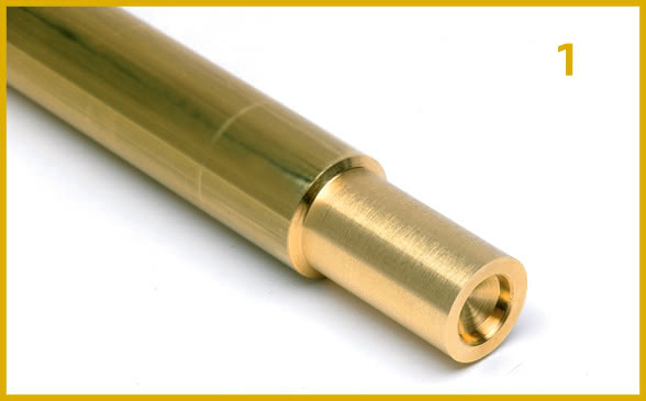 First stage. Close-up of a brass turned component during the roughing process, with end-milling and centering performed to ensure precision in subsequent machining.